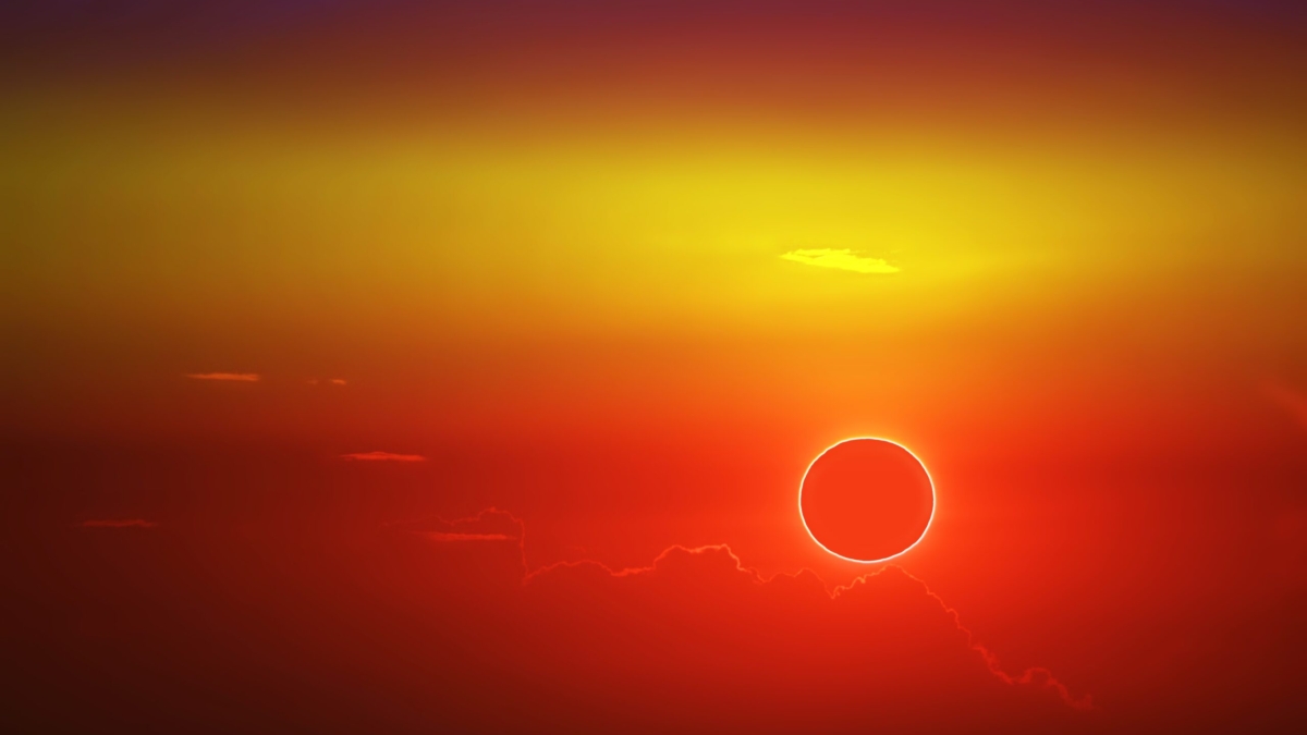 total sun eclipse over cloud sunset orange sky
