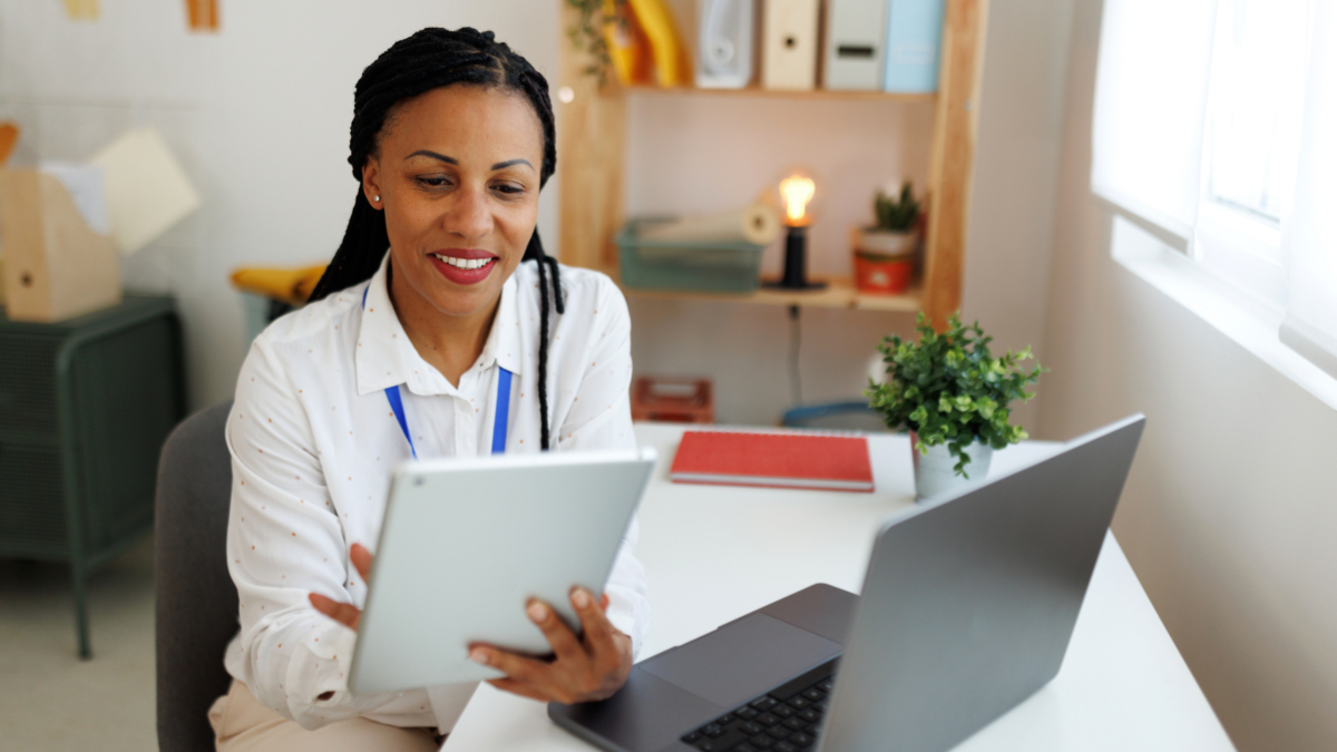 Young smiling businesswoman using digital tablet at office