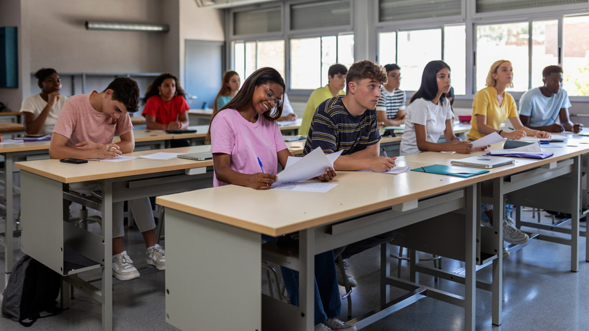Young group of high school students studying in classroom