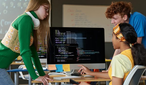 Students working over computer codes in team